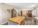 Kitchen island with butcher block countertop, open to dining area at 2350 Pleasant Dr, Longwood, FL 32779