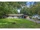 Charming ranch home with a covered carport and a neatly landscaped lawn at 2350 Pleasant Dr, Longwood, FL 32779