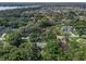 Aerial view showcasing a house surrounded by trees and other homes, near a lake at 2350 Pleasant Dr, Longwood, FL 32779