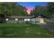 Charming ranch home with a covered carport and a neatly landscaped lawn at 2350 Pleasant Dr, Longwood, FL 32779