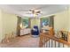 Bedroom with crib, dresser, and armchair at 2350 Pleasant Dr, Longwood, FL 32779