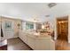 Bright living room with L-shaped sofa, hardwood floors, and a large TV at 2350 Pleasant Dr, Longwood, FL 32779