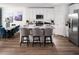 Modern kitchen with island, stainless steel appliances, and hardwood floors at 3514 Rutland Ln, Haines City, FL 33844