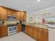 Open kitchen boasts granite countertops and ample cabinetry at 7651 Whisper Way # 401, Reunion, FL 34747
