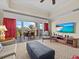 Spacious living room with balcony access and flat-screen TV at 7651 Whisper Way # 401, Reunion, FL 34747