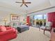 Living room with comfortable seating, large TV, and access to balcony at 7651 Whisper Way # 401, Reunion, FL 34747