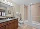 Guest bathroom with tub/shower combo and granite vanity at 7651 Whisper Way # 401, Reunion, FL 34747