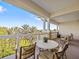 Spacious balcony with table and chairs, offering scenic views at 7651 Whisper Way # 401, Reunion, FL 34747