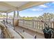 Spacious balcony with comfortable seating and views of lush landscaping at 7651 Whisper Way # 401, Reunion, FL 34747