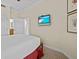 Guest bedroom with a queen bed and a TV at 7651 Whisper Way # 401, Reunion, FL 34747