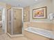 Spa-like bathroom with soaking tub and walk-in shower at 7651 Whisper Way # 401, Reunion, FL 34747