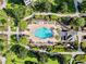 Community pool with lounge chairs and landscaping at 7651 Whisper Way # 401, Reunion, FL 34747