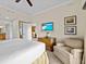 Main bedroom with king bed and sitting area at 7651 Whisper Way # 401, Reunion, FL 34747