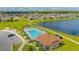 Aerial view of community pool, clubhouse, and surrounding neighborhood at 2048 Napoli Dr, Saint Cloud, FL 34771