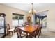 Bright dining room with a large wooden table and access to a patio at 3216 Lynrock Ave, Dundee, FL 33838