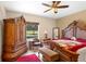 Main bedroom with a large bed, wooden armoire and plenty of natural light at 3216 Lynrock Ave, Dundee, FL 33838