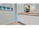 Double vanity bathroom with granite countertop, white cabinets, and tiled floor at 2928 Waterlily Way, Poinciana, FL 34759