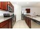 Modern kitchen with stainless steel appliances and granite countertops at 277 Ludisia Loop, Davenport, FL 33837