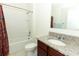 Bathroom with tub, toilet, and granite countertop at 277 Ludisia Loop, Davenport, FL 33837