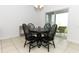 Dining area with four chairs and a round table by sliding door at 277 Ludisia Loop, Davenport, FL 33837