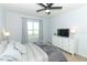 Spacious bedroom with a dresser, TV and a comfortable bed at 277 Ludisia Loop, Davenport, FL 33837