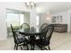 Bright dining area with four chairs and a round table, near kitchen at 277 Ludisia Loop, Davenport, FL 33837