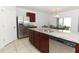 Kitchen with stainless steel appliances and granite countertops at 277 Ludisia Loop, Davenport, FL 33837