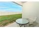 Small patio with table and chairs, overlooking a fenced backyard at 277 Ludisia Loop, Davenport, FL 33837
