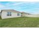 Back of house showing backyard and fence at 277 Ludisia Loop, Davenport, FL 33837