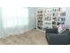 Home office features a bookcase, comfortable chair, and window at 277 Ludisia Loop, Davenport, FL 33837