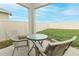 Small patio with wicker chairs and glass table at 277 Ludisia Loop, Davenport, FL 33837
