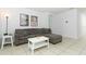 Cozy living room featuring a sectional sofa and a coffee table at 277 Ludisia Loop, Davenport, FL 33837