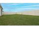 Grass backyard with a white vinyl fence at 277 Ludisia Loop, Davenport, FL 33837