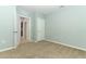 Bedroom with neutral walls, carpet, and an open door to hallway at 277 Ludisia Loop, Davenport, FL 33837
