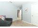 Spacious bedroom with neutral walls, carpet, and an open door at 277 Ludisia Loop, Davenport, FL 33837
