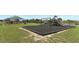 Community playground with swings, slides, and shade structure at 277 Ludisia Loop, Davenport, FL 33837