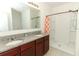 Bathroom boasts double sinks, granite countertop, and shower at 277 Ludisia Loop, Davenport, FL 33837