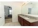 Double vanity bathroom with granite countertops and a view of bedroom at 277 Ludisia Loop, Davenport, FL 33837