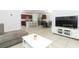 Open living room with view of kitchen and dining area at 277 Ludisia Loop, Davenport, FL 33837