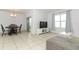 Bright dining area with table, chairs, and access to patio at 277 Ludisia Loop, Davenport, FL 33837
