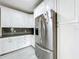 Bright kitchen with stainless steel refrigerator and white cabinets at 700 Eldridge St, Orlando, FL 32803