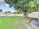 Backyard with large tree, detached garage, and fence at 700 Eldridge St, Orlando, FL 32803