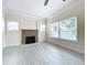 Bright living room featuring fireplace, tile floors, and large windows at 700 Eldridge St, Orlando, FL 32803