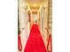 Long hallway with a red carpet runner at 1010 Strathmore Dr, Orlando, FL 32806