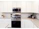 Stainless steel kitchen appliances and white shaker cabinets at 886 Grazie Loop, Davenport, FL 33837