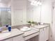 Double vanity bathroom with a large mirror and a walk-in shower at 886 Grazie Loop, Davenport, FL 33837