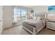 Bedroom with a queen-size bed and coastal decor at 3746 Bluethread Way, Poinciana, FL 34759