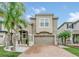 Two-story house with a brick driveway and landscaping at 2599 Nouveau Way, Kissimmee, FL 34741