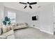 Relaxing sitting area featuring a sofa, tiled floors, and a wall-mounted TV at 2599 Nouveau Way, Kissimmee, FL 34741
