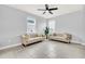 Light-filled sitting room with two beige sofas and tiled floors at 2599 Nouveau Way, Kissimmee, FL 34741
